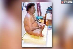 A professor performs nude Puja