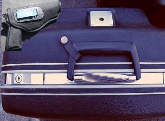 Suitcase with pistols, cheques
